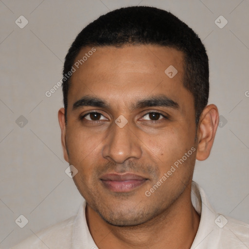Joyful latino young-adult male with short  black hair and brown eyes