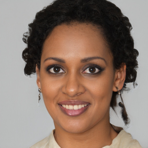 Joyful black young-adult female with medium  black hair and brown eyes