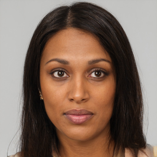 Neutral black young-adult female with long  brown hair and brown eyes