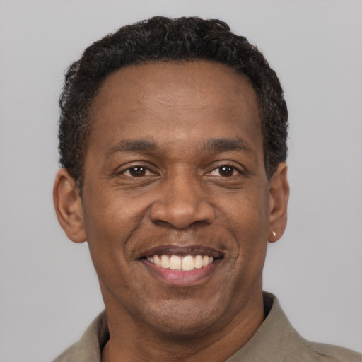 Joyful latino adult male with short  brown hair and brown eyes