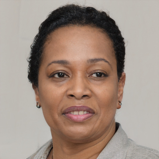 Joyful black adult female with short  brown hair and brown eyes