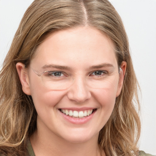 Joyful white young-adult female with long  brown hair and grey eyes