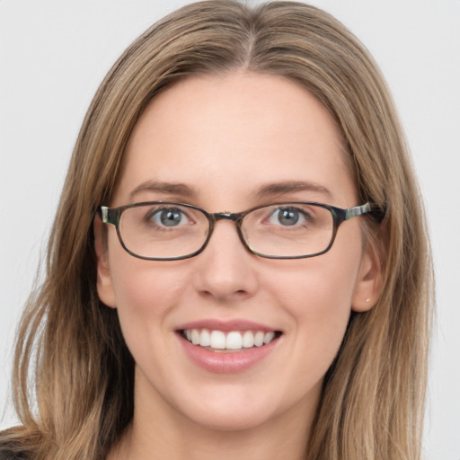 Joyful white young-adult female with long  brown hair and blue eyes