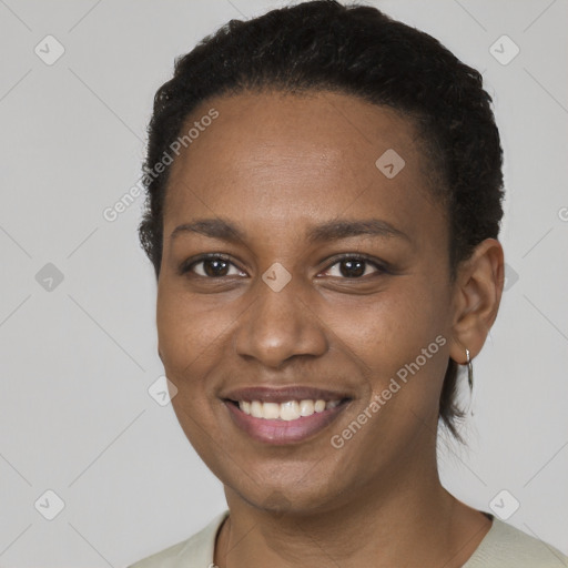 Joyful black young-adult female with short  brown hair and brown eyes