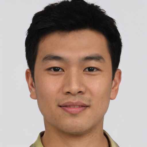 Joyful asian young-adult male with short  black hair and brown eyes