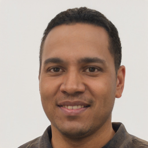 Joyful latino young-adult male with short  black hair and brown eyes