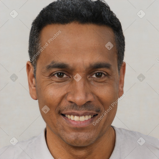 Joyful latino adult male with short  black hair and brown eyes