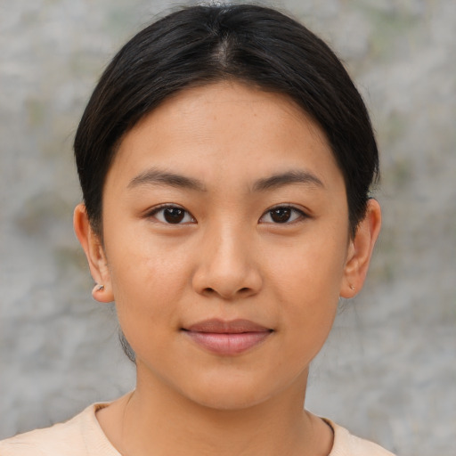 Joyful asian young-adult female with short  brown hair and brown eyes