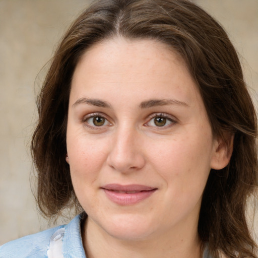 Joyful white young-adult female with medium  brown hair and green eyes