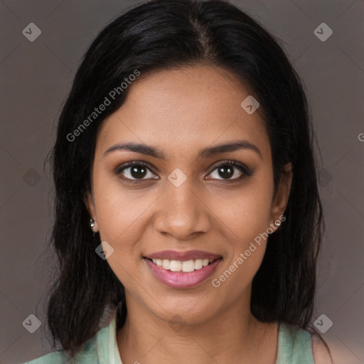 Joyful black young-adult female with long  brown hair and brown eyes