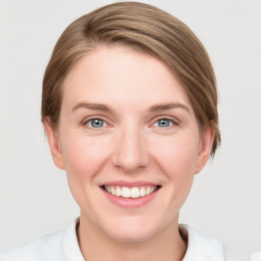 Joyful white young-adult female with medium  brown hair and blue eyes