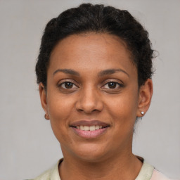 Joyful latino young-adult female with short  brown hair and brown eyes