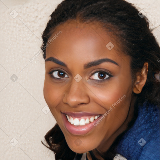 Joyful black young-adult female with long  brown hair and brown eyes