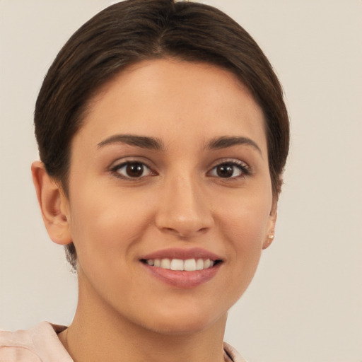 Joyful white young-adult female with short  brown hair and brown eyes