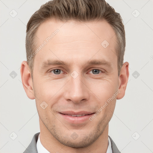 Joyful white young-adult male with short  brown hair and grey eyes