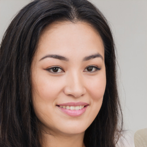 Joyful asian young-adult female with long  brown hair and brown eyes