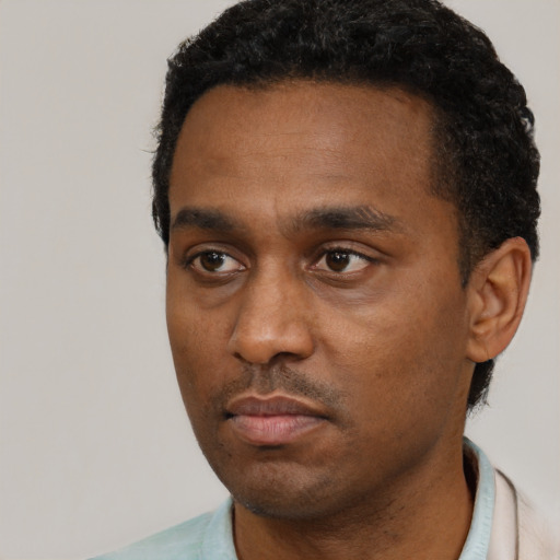 Neutral black young-adult male with short  black hair and brown eyes
