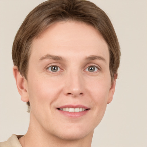 Joyful white young-adult female with short  brown hair and grey eyes