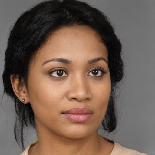 Joyful latino young-adult female with medium  brown hair and brown eyes