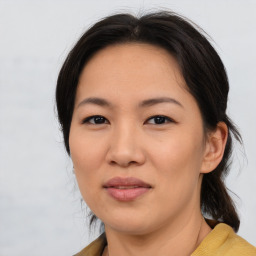 Joyful asian young-adult female with medium  brown hair and brown eyes