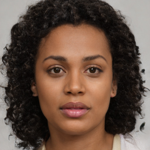 Neutral black young-adult female with medium  brown hair and brown eyes