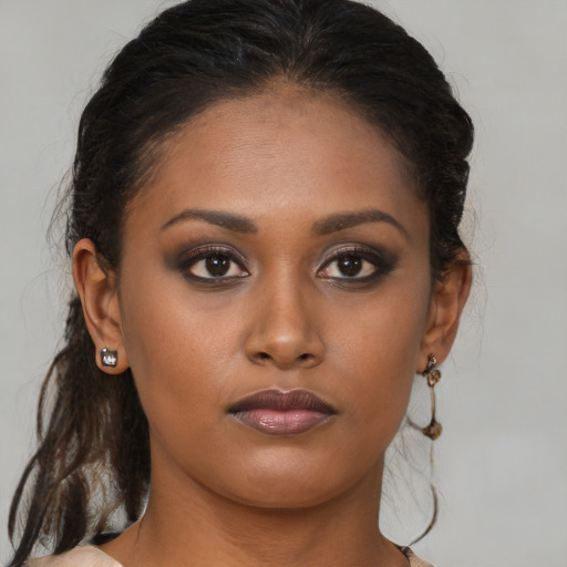 Neutral black young-adult female with medium  brown hair and brown eyes