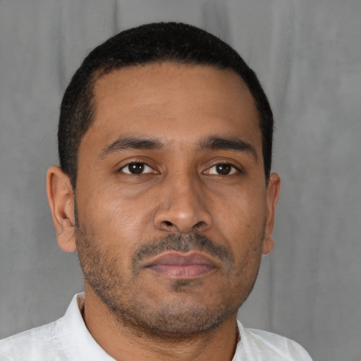 Neutral latino young-adult male with short  brown hair and brown eyes