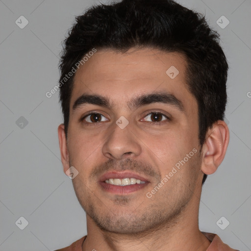 Joyful white young-adult male with short  black hair and brown eyes