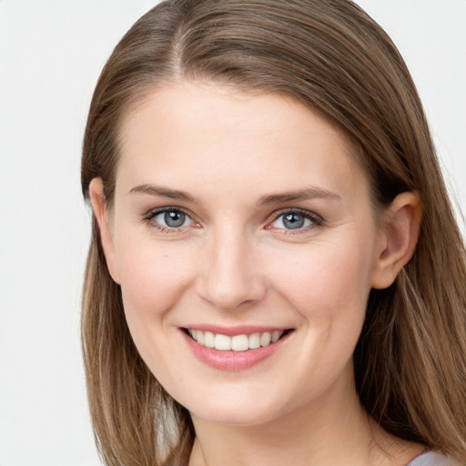 Joyful white young-adult female with long  brown hair and grey eyes