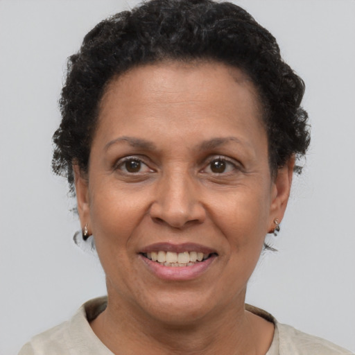 Joyful black adult female with short  brown hair and brown eyes