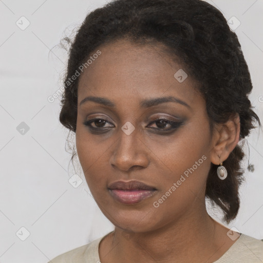 Joyful black young-adult female with long  brown hair and brown eyes