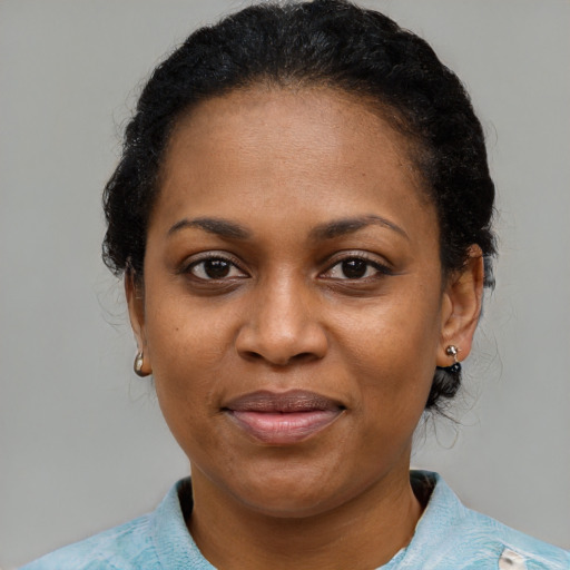 Joyful black adult female with medium  black hair and brown eyes
