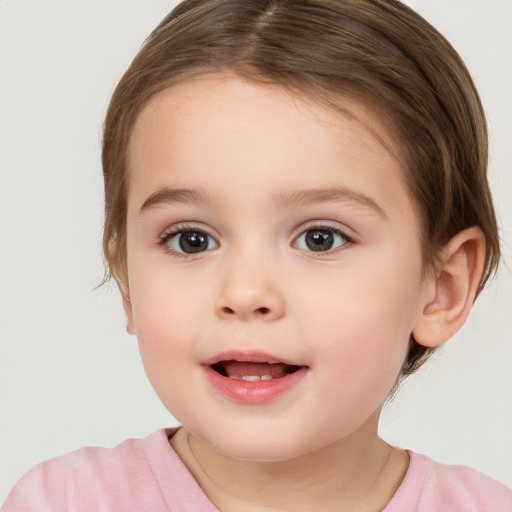 Joyful white child female with short  brown hair and brown eyes