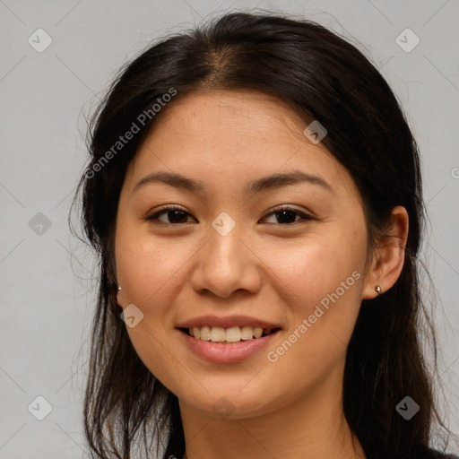 Joyful asian young-adult female with long  brown hair and brown eyes