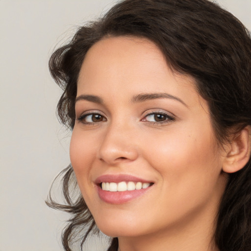 Joyful white young-adult female with medium  brown hair and brown eyes