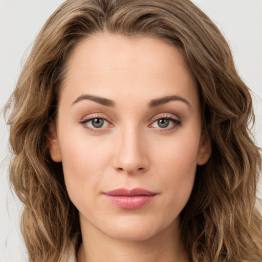 Joyful white young-adult female with long  brown hair and green eyes