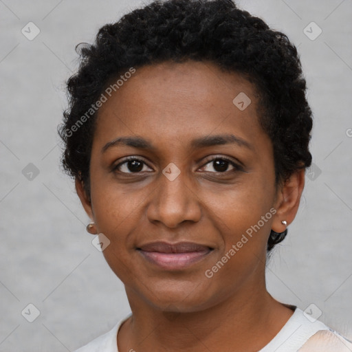 Joyful black young-adult female with short  black hair and brown eyes