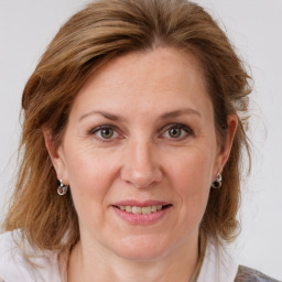 Joyful white adult female with medium  brown hair and grey eyes