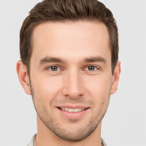 Joyful white young-adult male with short  brown hair and brown eyes