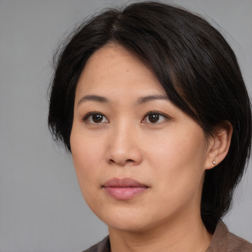 Neutral asian young-adult female with medium  brown hair and brown eyes
