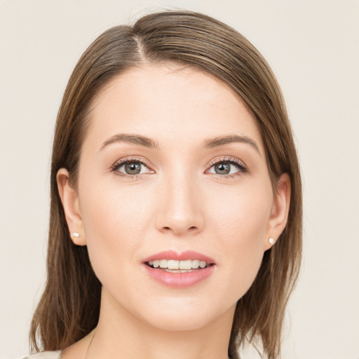 Joyful white young-adult female with medium  brown hair and green eyes