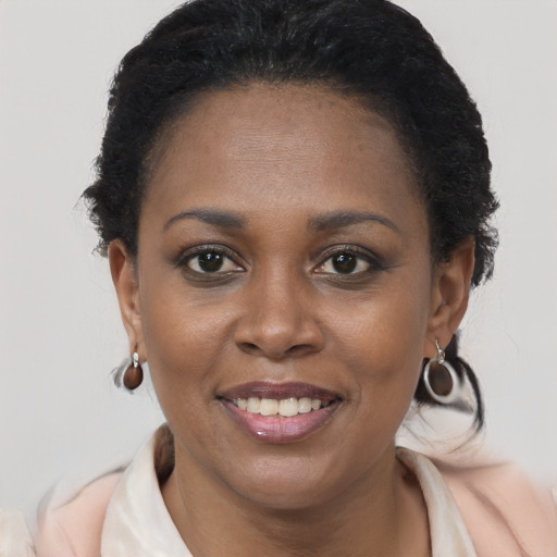 Joyful black young-adult female with short  brown hair and brown eyes