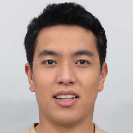 Joyful asian young-adult male with short  black hair and brown eyes