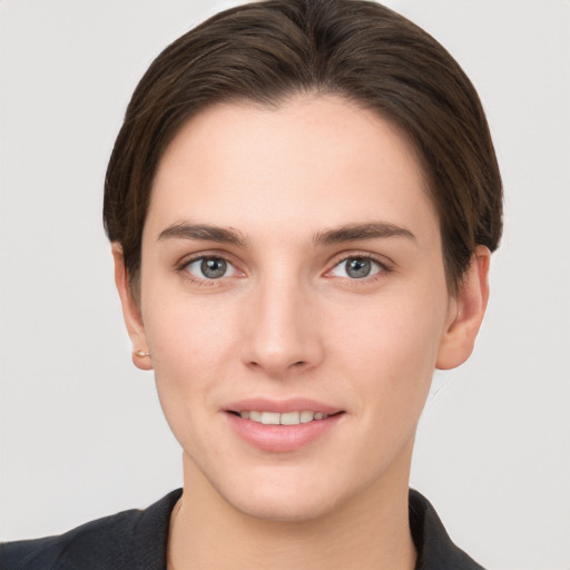 Joyful white young-adult female with short  brown hair and brown eyes