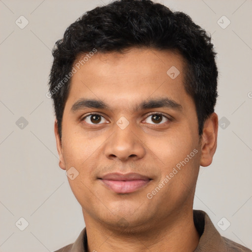 Joyful latino young-adult male with short  black hair and brown eyes