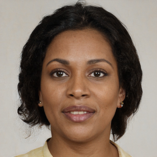 Joyful black young-adult female with medium  brown hair and brown eyes
