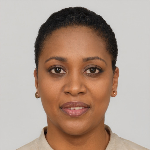 Joyful black young-adult female with short  black hair and brown eyes