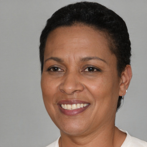 Joyful black adult female with short  brown hair and brown eyes