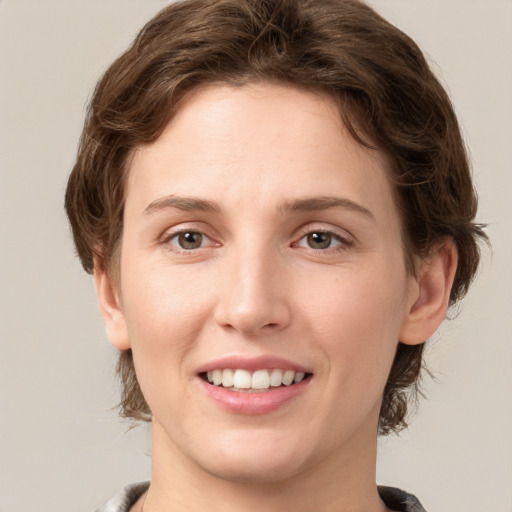 Joyful white young-adult female with medium  brown hair and green eyes