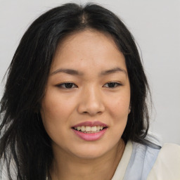 Joyful asian young-adult female with long  brown hair and brown eyes